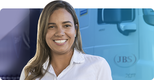 Mulher parda sorrindo com mexas loiras no cabelo com caminhão da JBS no fundo