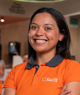 Swift employee smiling in an orange polo shirt.