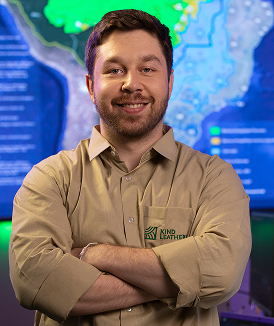 Man smiling with arms crossed in a Kind Leather shirt.
