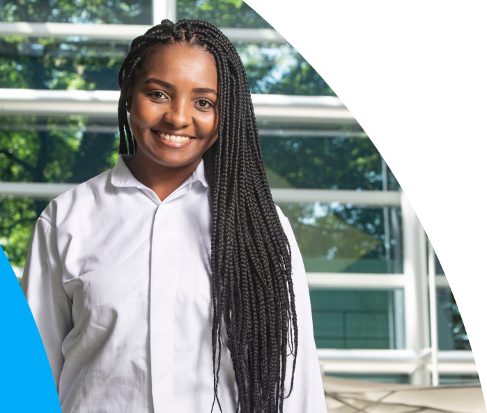 Smiling young intern in a corporate environment